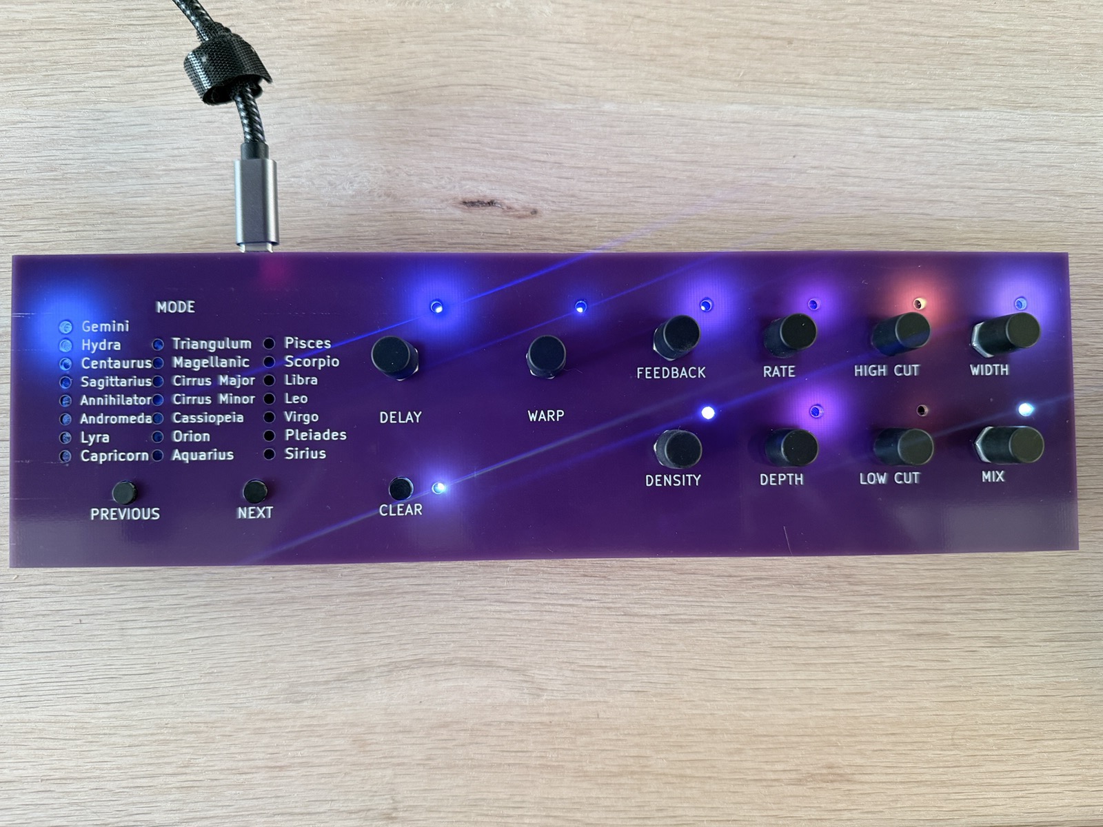 The first Press controller, for Supermassive: a purple circuit board used as the front panel, with ten black knobs, a clear button, previous and next buttons, and 22 lit mode names from Gemini to Sirius.