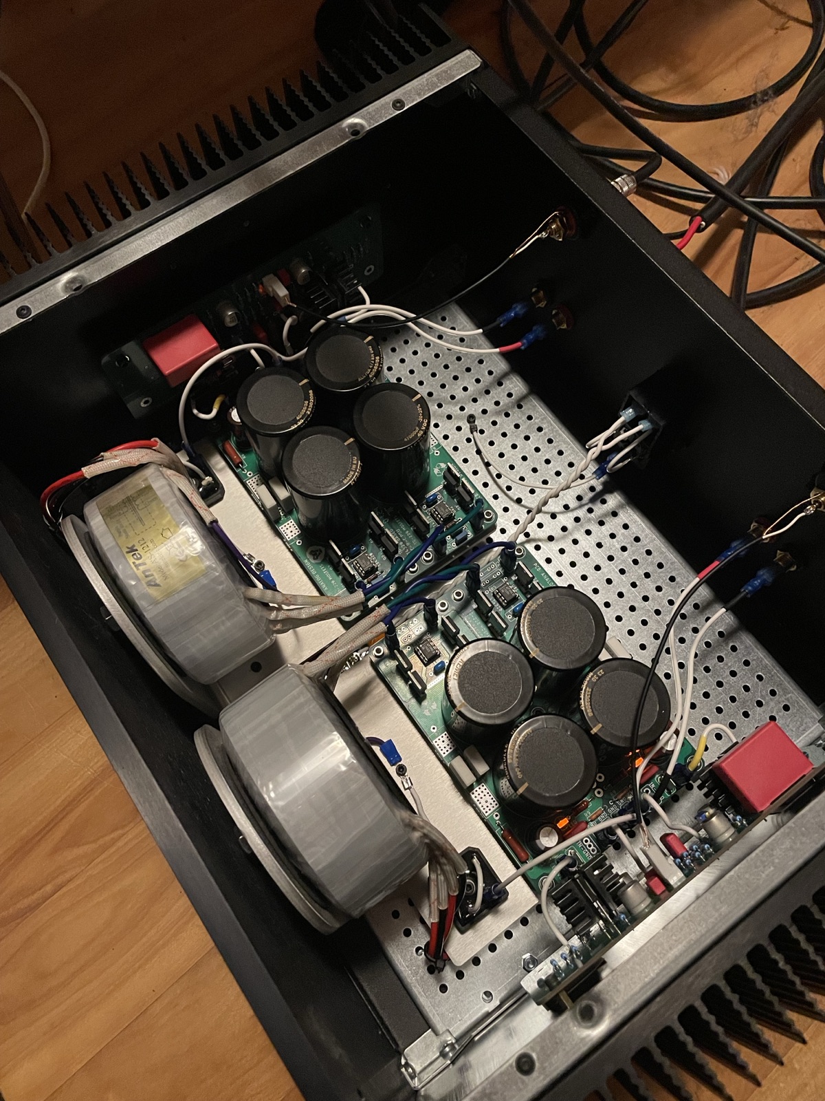 The amplifier's insides from an angle, showing the two transformers and the two channel boards.